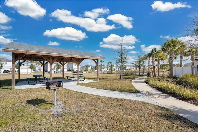 view of property's community with a gazebo, fence, and a lawn