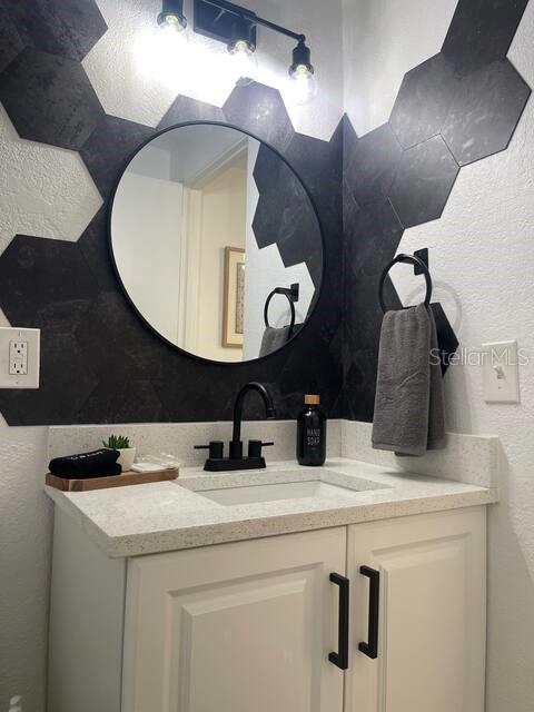 1405 Smith Dr N, Titusville, FL 32780 - bathroom with vanity and a textured wall