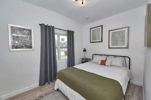 1405 Smith Dr N, Titusville, FL 32780 - bedroom with baseboards and light wood-style flooring
