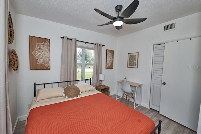 1405 Smith Dr N, Titusville, FL 32780 - bedroom with baseboards, visible vents, wood finished floors, and a textured ceiling