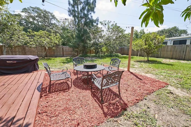1405 Smith Dr N, Titusville, FL 32780 - view of yard featuring a fenced backyard, a fire pit, and a deck
