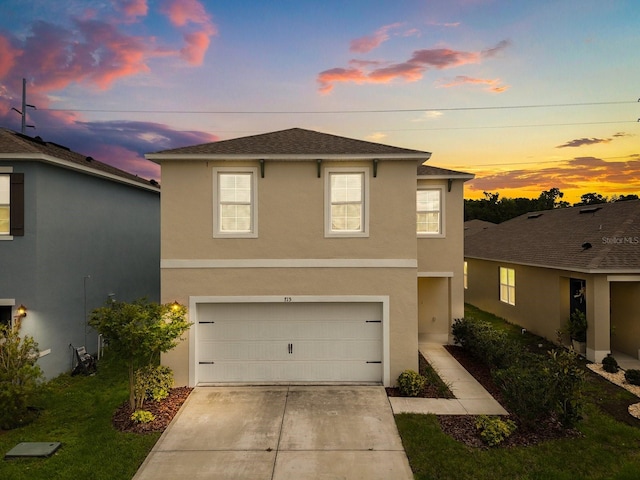 715 Chinoy Rd, Davenport, FL 33837 - traditional-style home featuring concrete driveway, roof with shingles, an attached garage, and stucco siding
