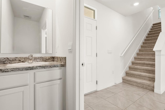 715 Chinoy Rd, Davenport, FL 33837 - bathroom with tile patterned floors, vanity, baseboards, and visible vents
