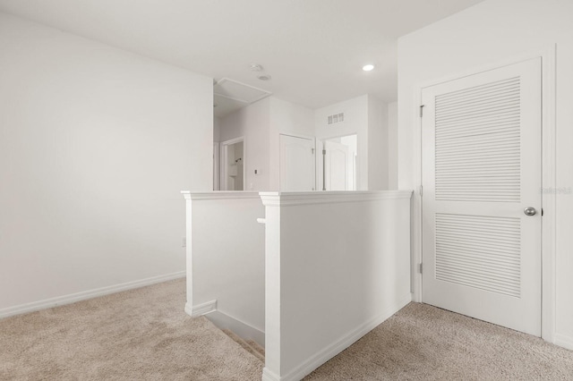 715 Chinoy Rd, Davenport, FL 33837 - hallway with visible vents, an upstairs landing, carpet flooring, and attic access