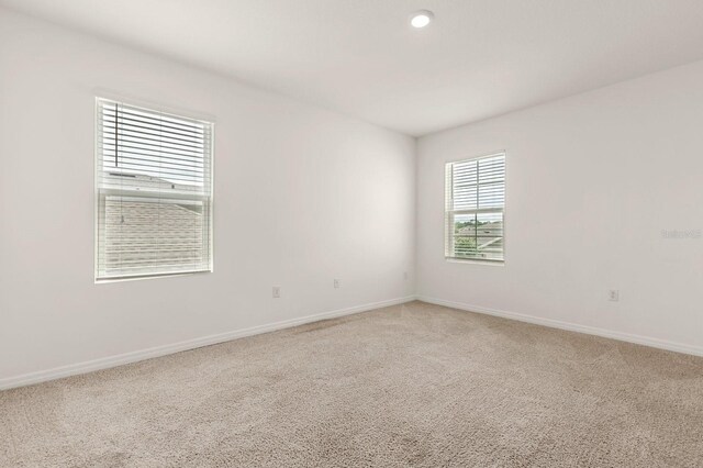 715 Chinoy Rd, Davenport, FL 33837 - empty room featuring light colored carpet, baseboards, and recessed lighting