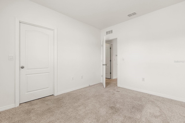 715 Chinoy Rd, Davenport, FL 33837 - unfurnished bedroom featuring visible vents, baseboards, and light colored carpet