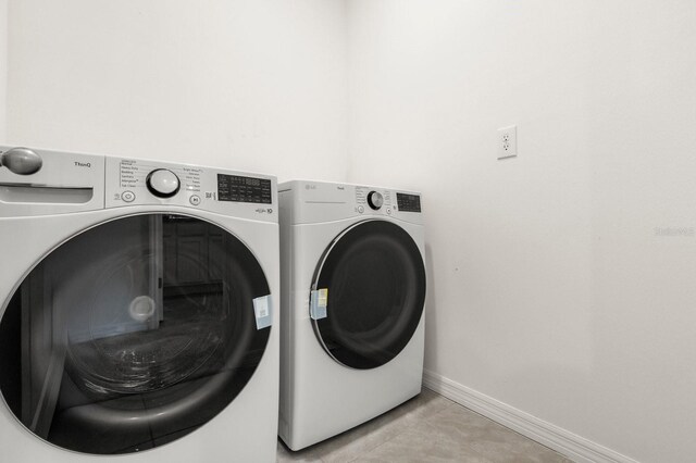 715 Chinoy Rd, Davenport, FL 33837 - washroom with baseboards, washer and dryer, and laundry area