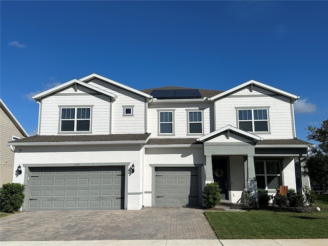 3399 Buoy Cir, Winter Garden, FL 34787 - view of front of house featuring solar panels, decorative driveway, an attached garage, and roof with shingles