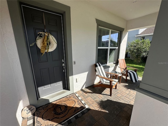3399 Buoy Cir, Winter Garden, FL 34787 - property entrance featuring stucco siding and covered porch