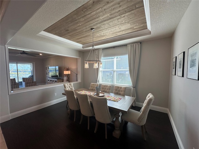 3399 Buoy Cir, Winter Garden, FL 34787 - dining room featuring a textured ceiling, baseboards, wood finished floors, a raised ceiling, and wood ceiling