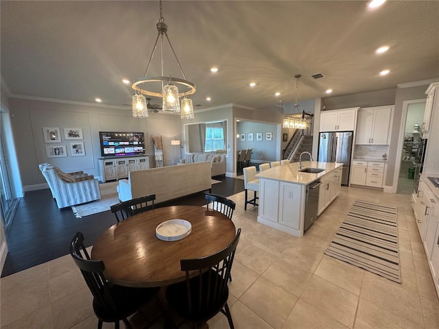 3399 Buoy Cir, Winter Garden, FL 34787 - dining area with light tile patterned floors, visible vents, ornamental molding, recessed lighting, and an inviting chandelier