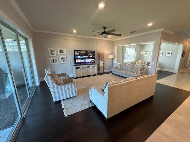3399 Buoy Cir, Winter Garden, FL 34787 - living room featuring wood finished floors, a decorative wall, visible vents, ceiling fan, and ornamental molding