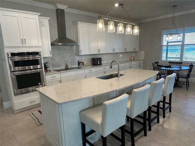 3399 Buoy Cir, Winter Garden, FL 34787 - kitchen featuring black electric cooktop, crown molding, double oven, a sink, and wall chimney range hood