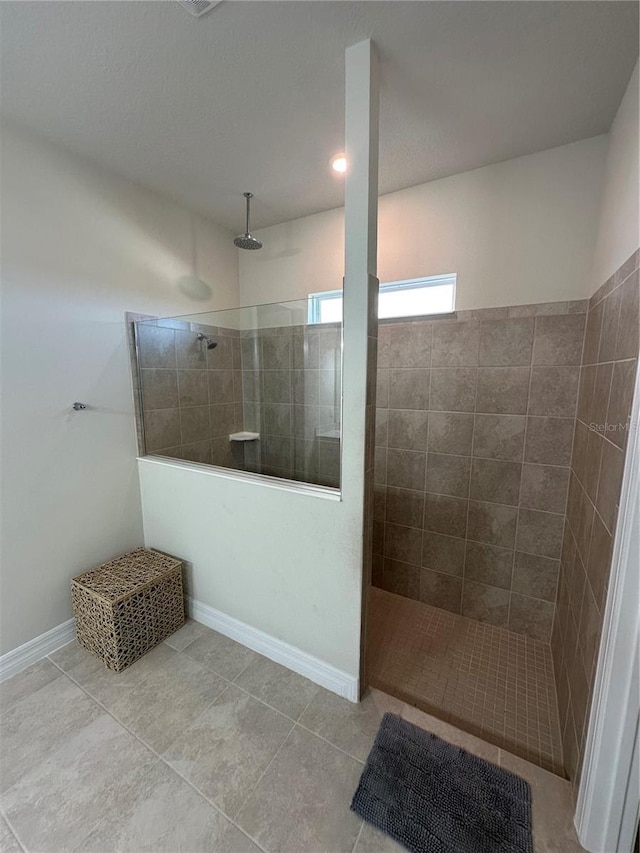 3399 Buoy Cir, Winter Garden, FL 34787 - bathroom featuring tile patterned flooring, baseboards, and a walk in shower