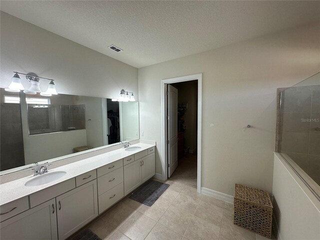 3399 Buoy Cir, Winter Garden, FL 34787 - bathroom featuring a sink, double vanity, visible vents, and a spacious closet