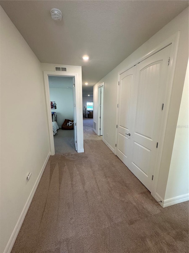 3399 Buoy Cir, Winter Garden, FL 34787 - hallway with baseboards, carpet flooring, and visible vents