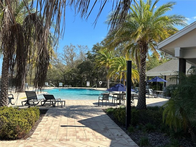 3399 Buoy Cir, Winter Garden, FL 34787 - community pool with fence and a patio area