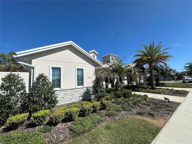 3399 Buoy Cir, Winter Garden, FL 34787 - view of home's exterior with stone siding, fence, and stucco siding