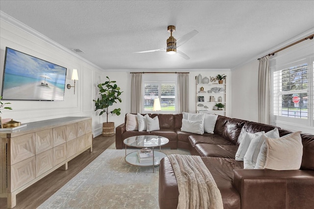 5205 Saint Regis Pl, Belle Isle, FL 32812 - living area featuring crown molding, wood finished floors, a ceiling fan, and visible vents