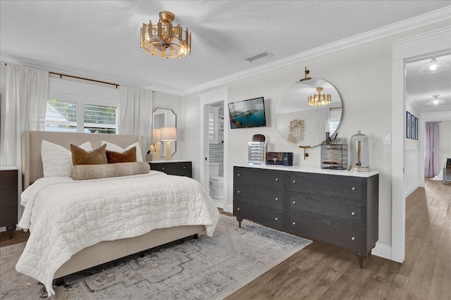 5205 Saint Regis Pl, Belle Isle, FL 32812 - bedroom featuring crown molding, visible vents, a notable chandelier, and wood finished floors