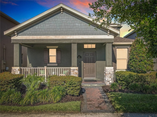 9432 Komika Ln, Winter Garden, FL 34787 - view of front facade with stucco siding and a porch