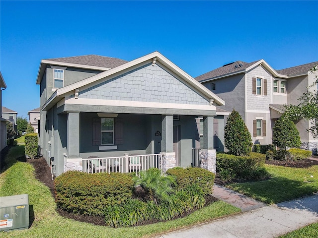 9432 Komika Ln, Winter Garden, FL 34787 - bungalow-style house featuring a porch, stucco siding, and stone siding