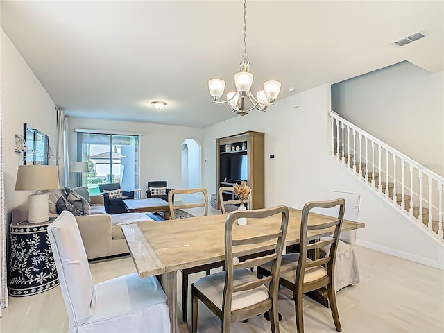 9432 Komika Ln, Winter Garden, FL 34787 - dining space featuring a chandelier, stairs, arched walkways, and visible vents