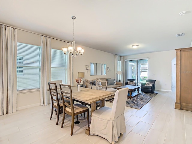 9432 Komika Ln, Winter Garden, FL 34787 - dining room with a chandelier, baseboards, arched walkways, and visible vents