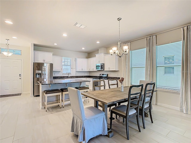 9432 Komika Ln, Winter Garden, FL 34787 - dining space featuring recessed lighting, visible vents, baseboards, and a notable chandelier