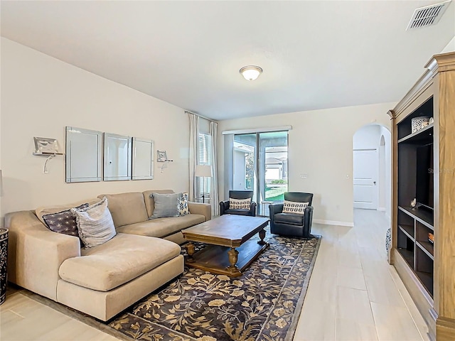 9432 Komika Ln, Winter Garden, FL 34787 - living area featuring visible vents, baseboards, and arched walkways