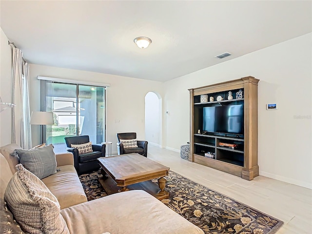 9432 Komika Ln, Winter Garden, FL 34787 - living area with visible vents, baseboards, and arched walkways