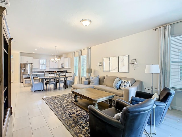 9432 Komika Ln, Winter Garden, FL 34787 - living room with light tile patterned floors, a notable chandelier, and visible vents