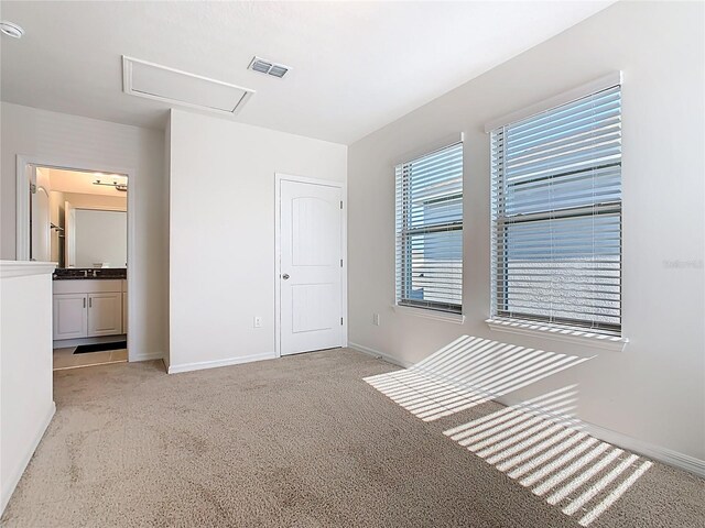 9432 Komika Ln, Winter Garden, FL 34787 - unfurnished bedroom with light colored carpet, attic access, visible vents, and baseboards