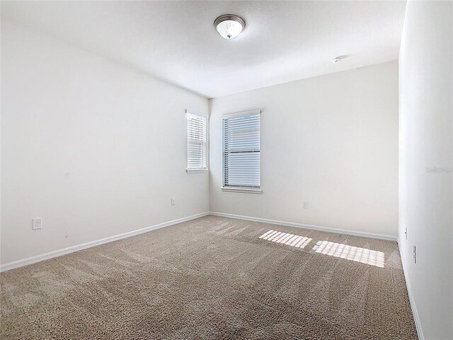 9432 Komika Ln, Winter Garden, FL 34787 - unfurnished room featuring baseboards and light colored carpet