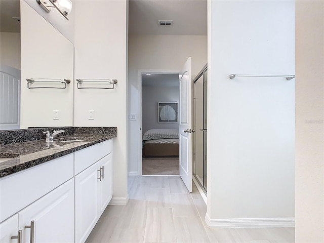 9432 Komika Ln, Winter Garden, FL 34787 - full bathroom featuring a stall shower, baseboards, visible vents, a sink, and double vanity