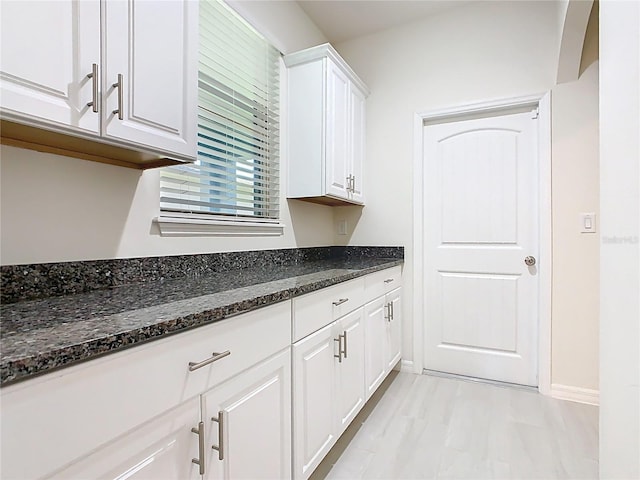 9432 Komika Ln, Winter Garden, FL 34787 - interior space featuring baseboards, dark stone countertops, and white cabinets