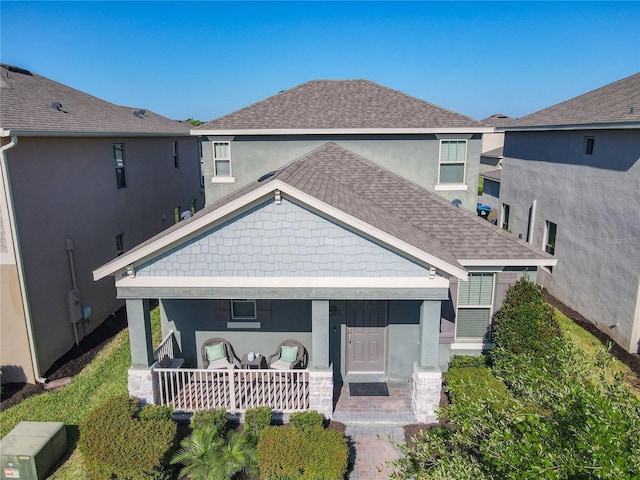 9432 Komika Ln, Winter Garden, FL 34787 - view of front of home with stucco siding, a shingled roof, and covered porch