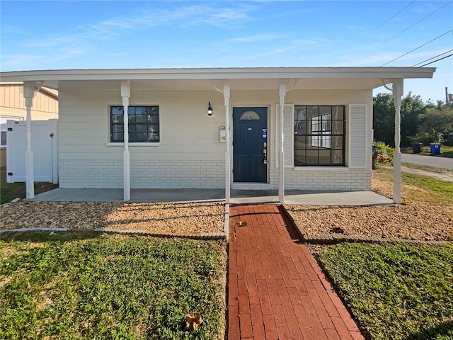 701 71st Ave N, Saint Petersburg, FL 33702 - doorway to property with a porch and brick siding