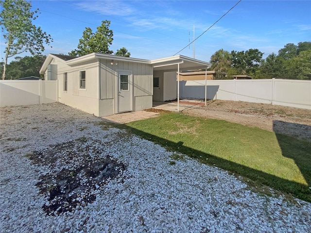 701 71st Ave N, Saint Petersburg, FL 33702 - back of property with a fenced backyard and a patio