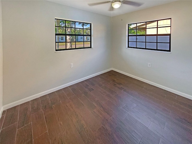701 71st Ave N, Saint Petersburg, FL 33702 - empty room featuring ceiling fan, dark wood-style floors, baseboards, and healthy amount of natural light