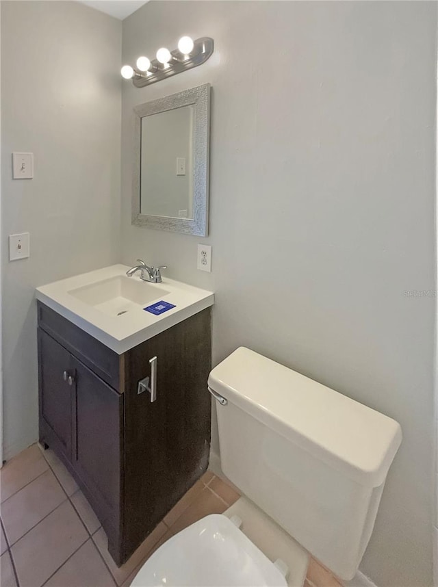 701 71st Ave N, Saint Petersburg, FL 33702 - bathroom featuring vanity, toilet, and tile patterned flooring