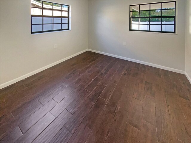 701 71st Ave N, Saint Petersburg, FL 33702 - unfurnished room featuring dark wood-type flooring and baseboards