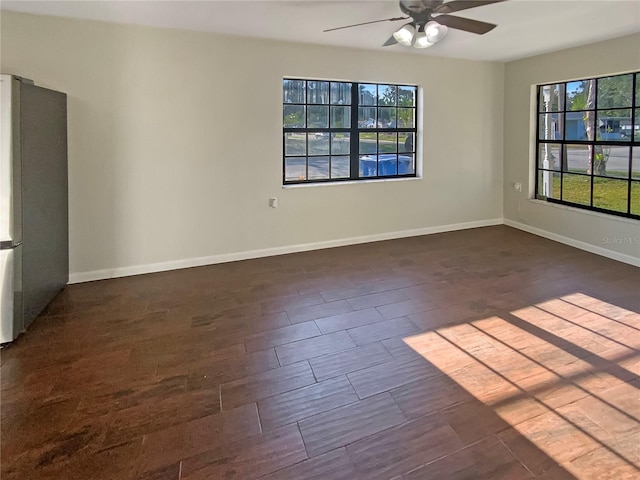 701 71st Ave N, Saint Petersburg, FL 33702 - spare room featuring a ceiling fan, baseboards, and dark wood-style flooring