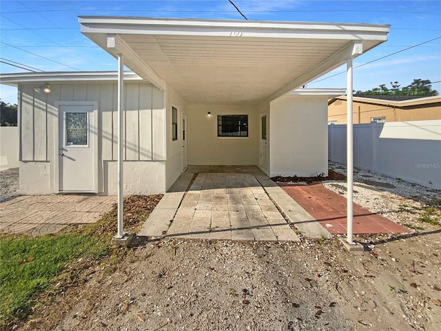 701 71st Ave N, Saint Petersburg, FL 33702 - rear view of house with an attached carport and board and batten siding