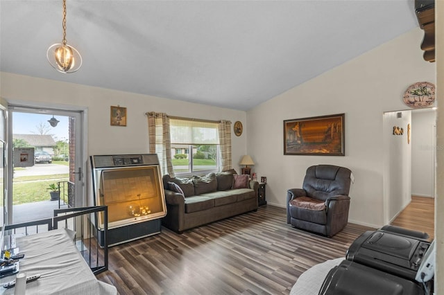 living room with baseboards, lofted ceiling, and wood finished floors