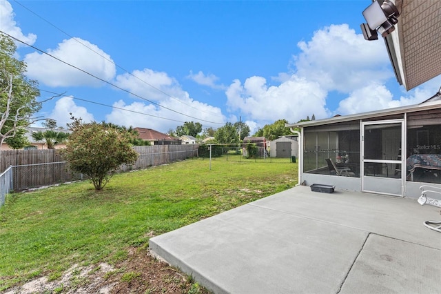 view of yard featuring a fenced backyard, a sunroom, and a patio area