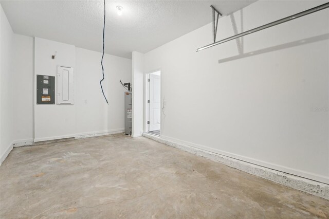 garage featuring electric water heater and electric panel