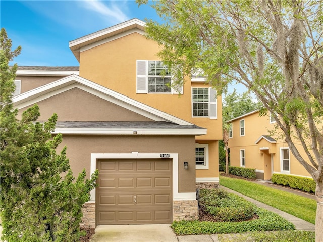 3166 Rodrick Cir, Orlando, FL 32824 - view of front of property featuring stucco siding, an attached garage, and stone siding