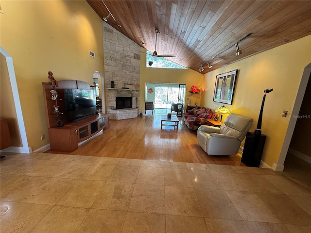 913 Red Fox Rd, Altamonte Springs, FL 32714 - tiled living area featuring wood ceiling, track lighting, lofted ceiling, a fireplace, and baseboards