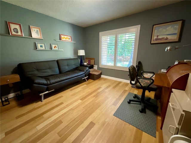 913 Red Fox Rd, Altamonte Springs, FL 32714 - home office featuring wood finished floors, a textured ceiling, and baseboards